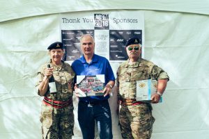 Nigel Matthews (middle) of Hagerty Collector Car Insuance presents the 2016 ABFM Featured Marque Award to Doreen and Ian Newby for their 1985 Land Rover 110.