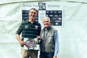 John Dickinson (right) co-owner Synchromesh Wines, presents Wayne Shalagan with the First-Time Entrant Award for his 1966 Triumph TR4A.