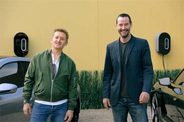 Actors Alex Winter (left) and Keanu Reeves ready their Taycans with a full charge before "Going the Distance."